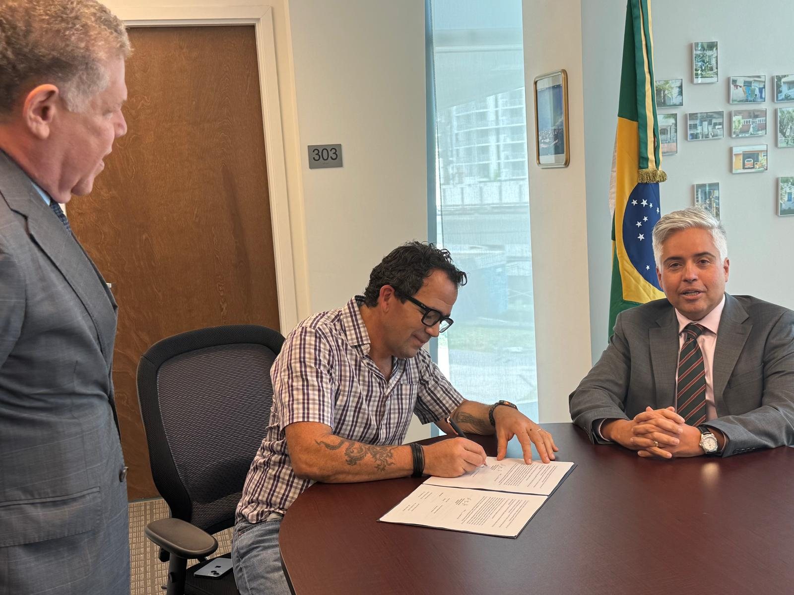 Marcelo Zuffo signs the delivery record at the Consulate General of Brazil in Miami
